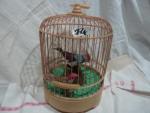 Cage à oiseaux bakélite/plastique écru base ronde, les barreaux en...
