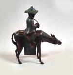 Toba sur sa mule, sujet en bronze et émaux champlevés....