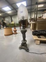 Lampe en bronze à décor de caryatides surmontée d'un obus...