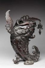 Carpe à tête de dragon émergeant des flots en bronze,...